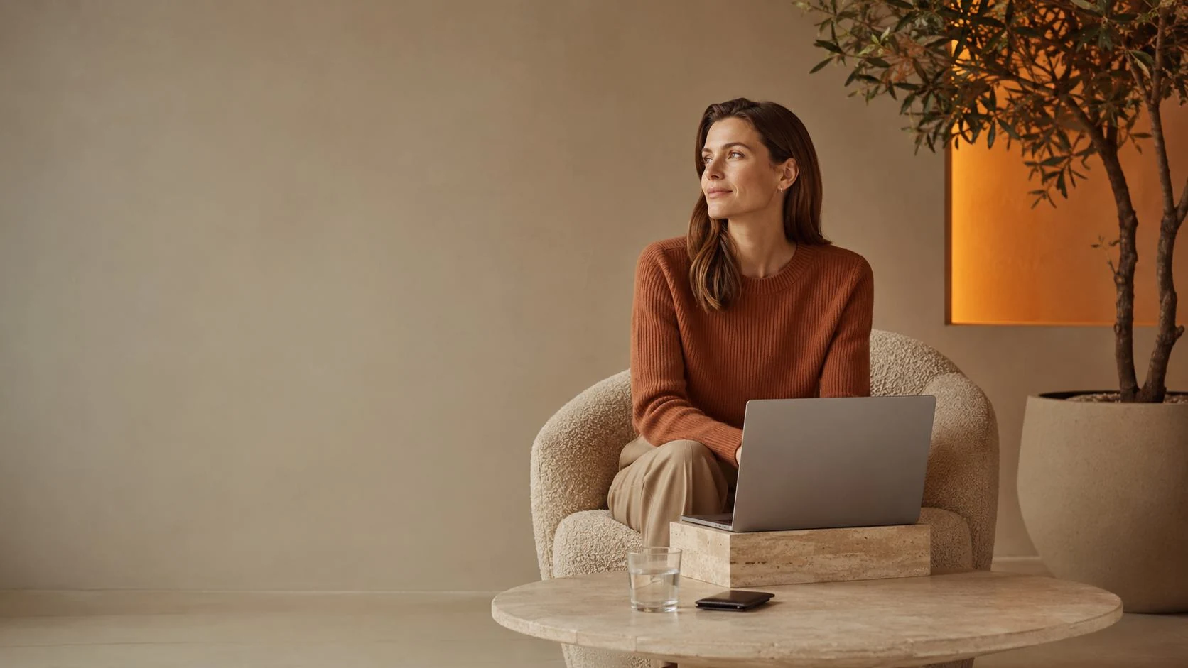 A DigiDoe team member working on a laptop in a warm, quiet office
