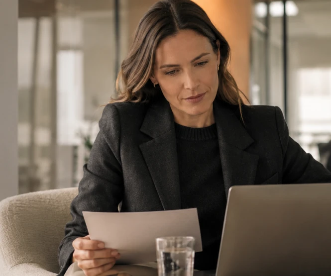A DigiDoe team member reviewing account paperwork with a client in an office